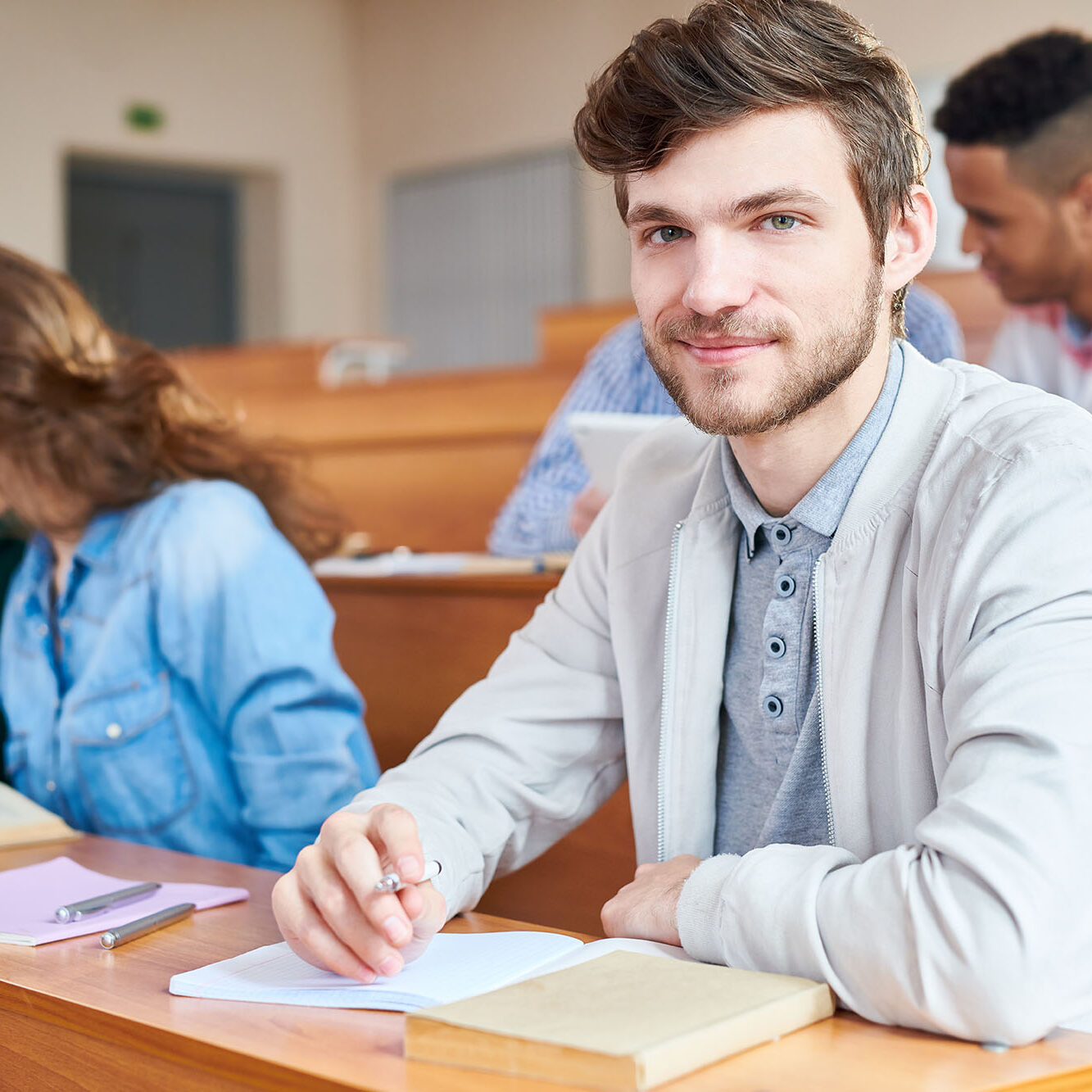 Portrait of college student sitting at desk during a lesson